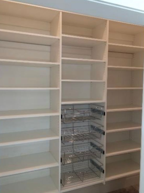 White pantry with shelves and pull-out wire baskets.