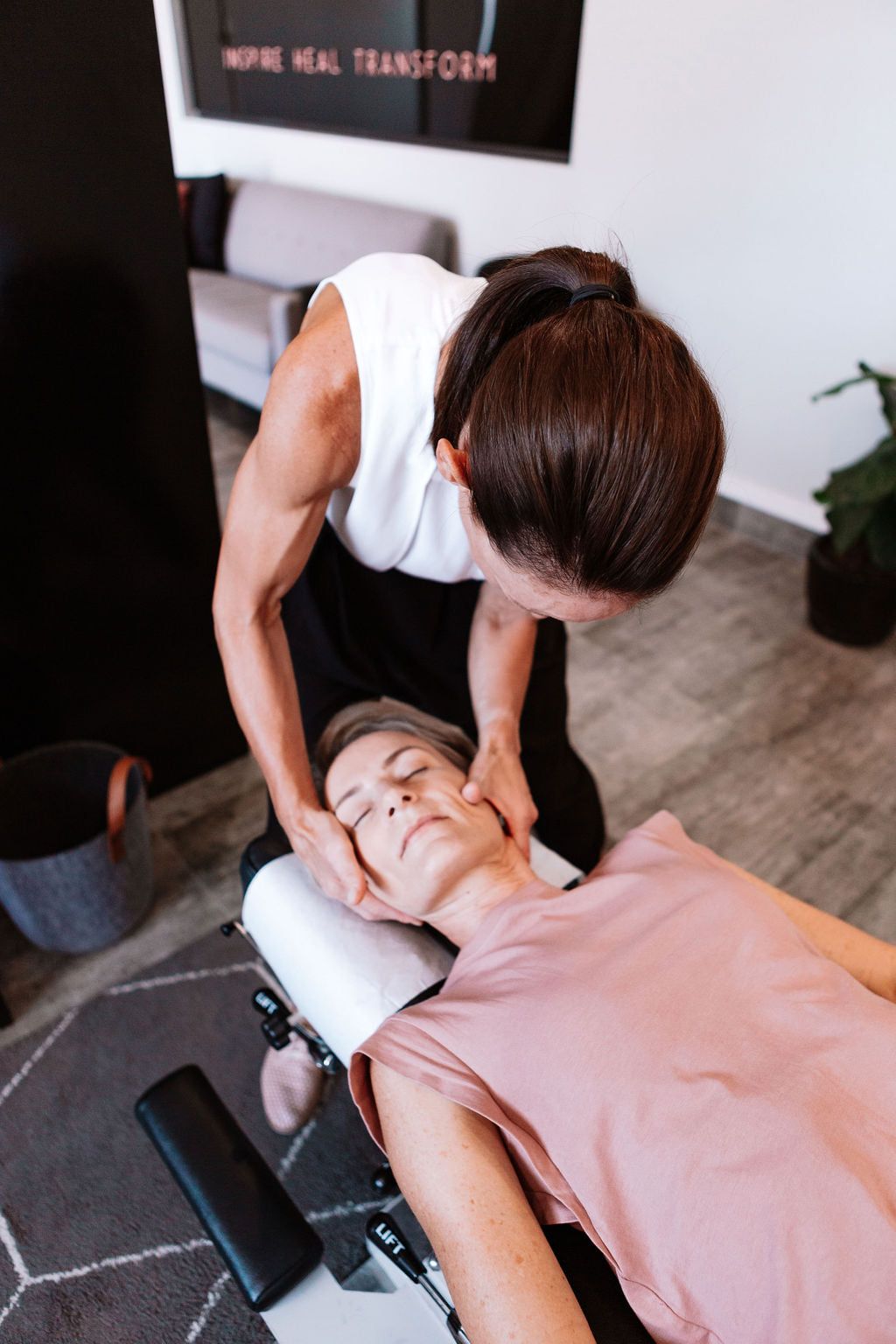 A person receiving a neck adjustment from a healthcare provider in a clinic setting. — The Health Studio Sunshine Coast In Mooloolaba, QLD