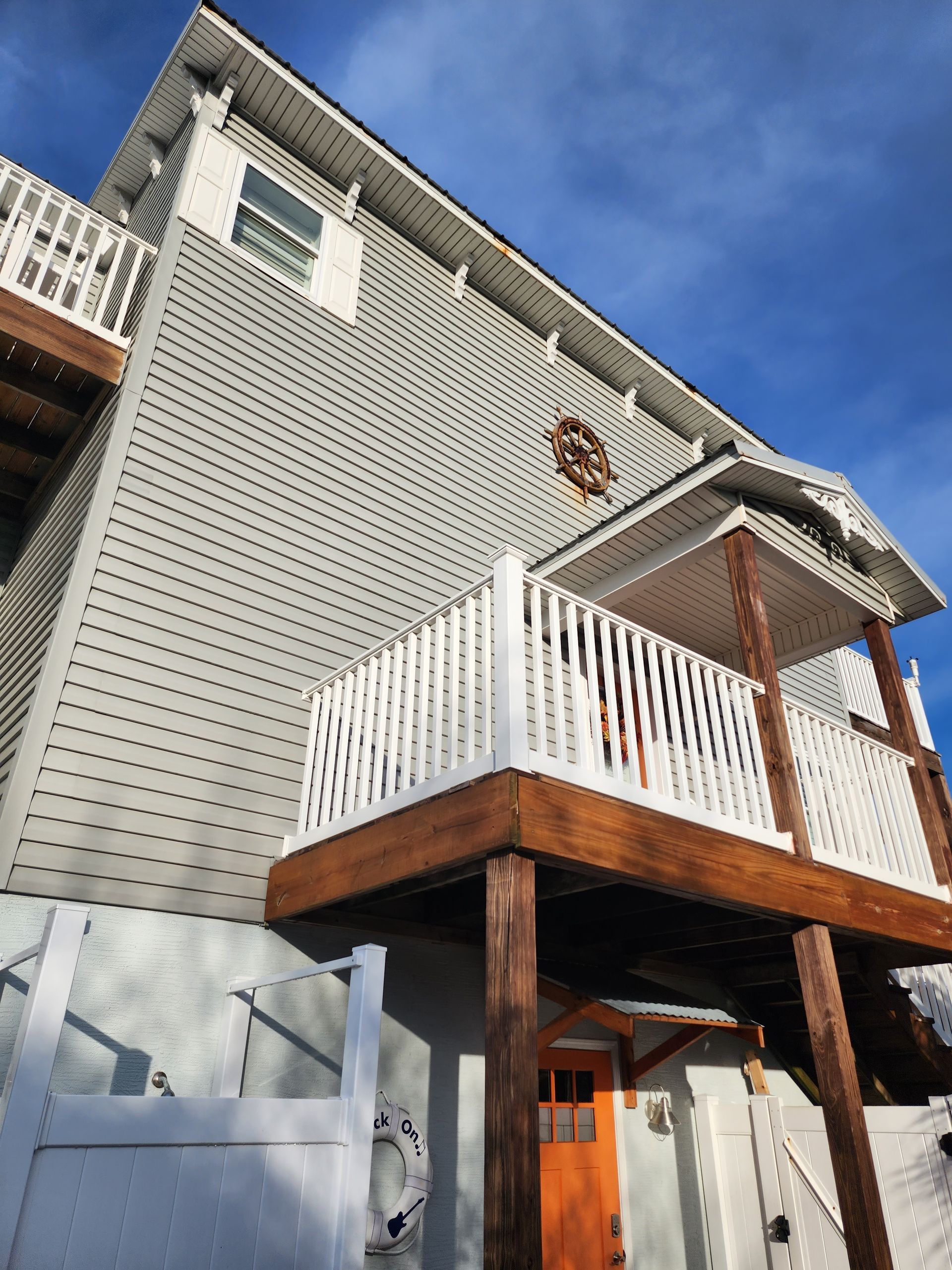A house with a balcony and a white railing
