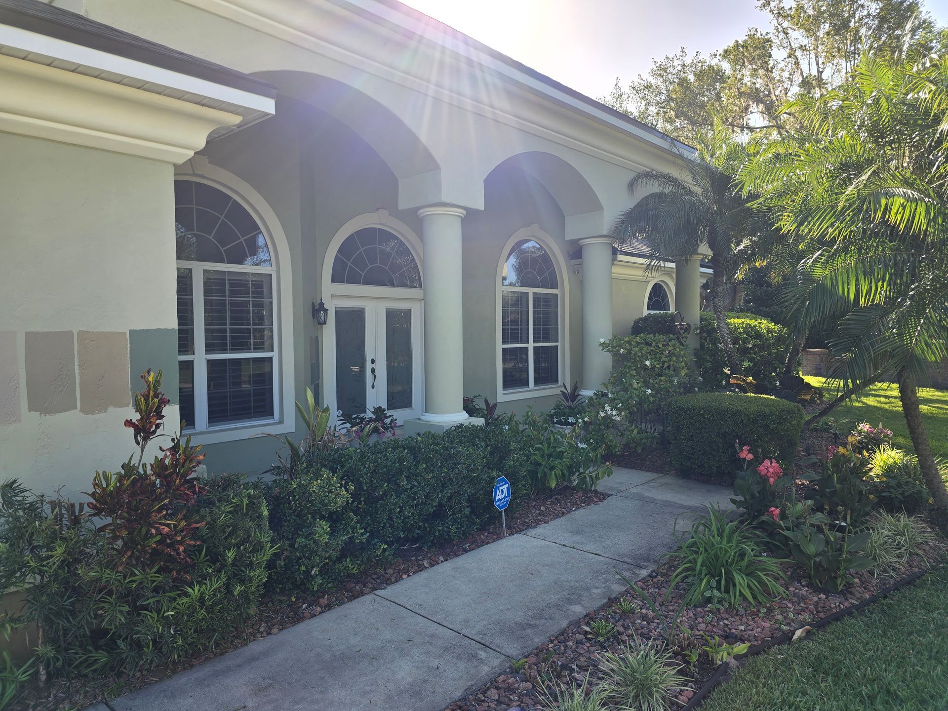 A large white house with a walkway leading to it