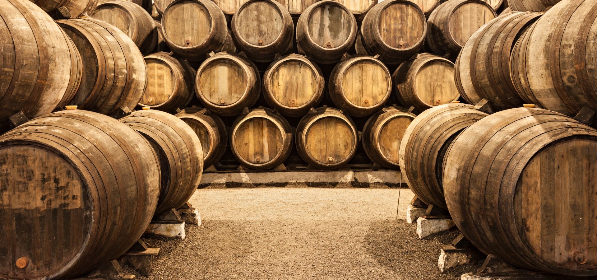 A traditional Portuguese wine cellar with rows of wooden casks, aging fine wines to perfection.
