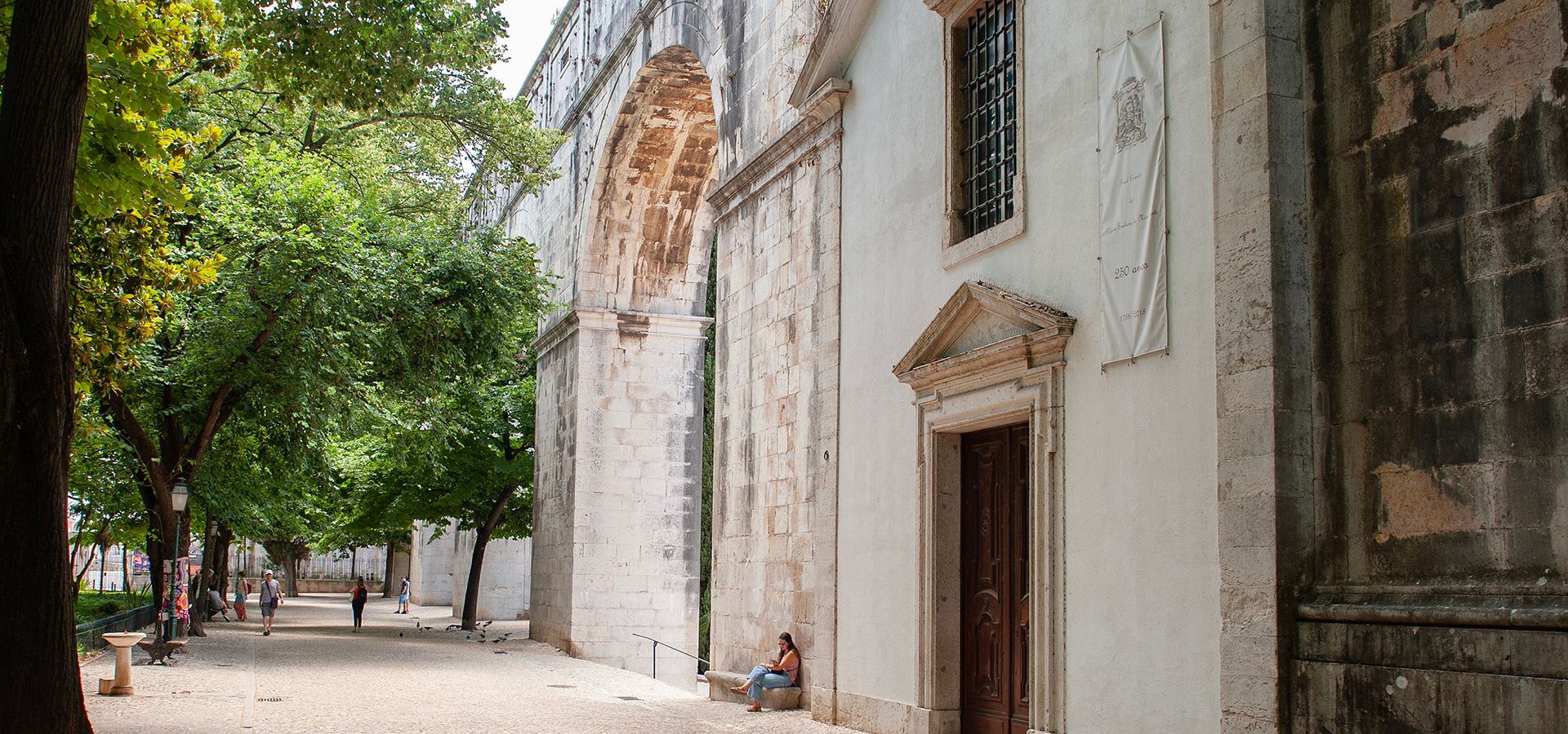 The historic 18th-century Águas Livres Aqueduct stretching across Lisbon, a remarkable feat of engineering.