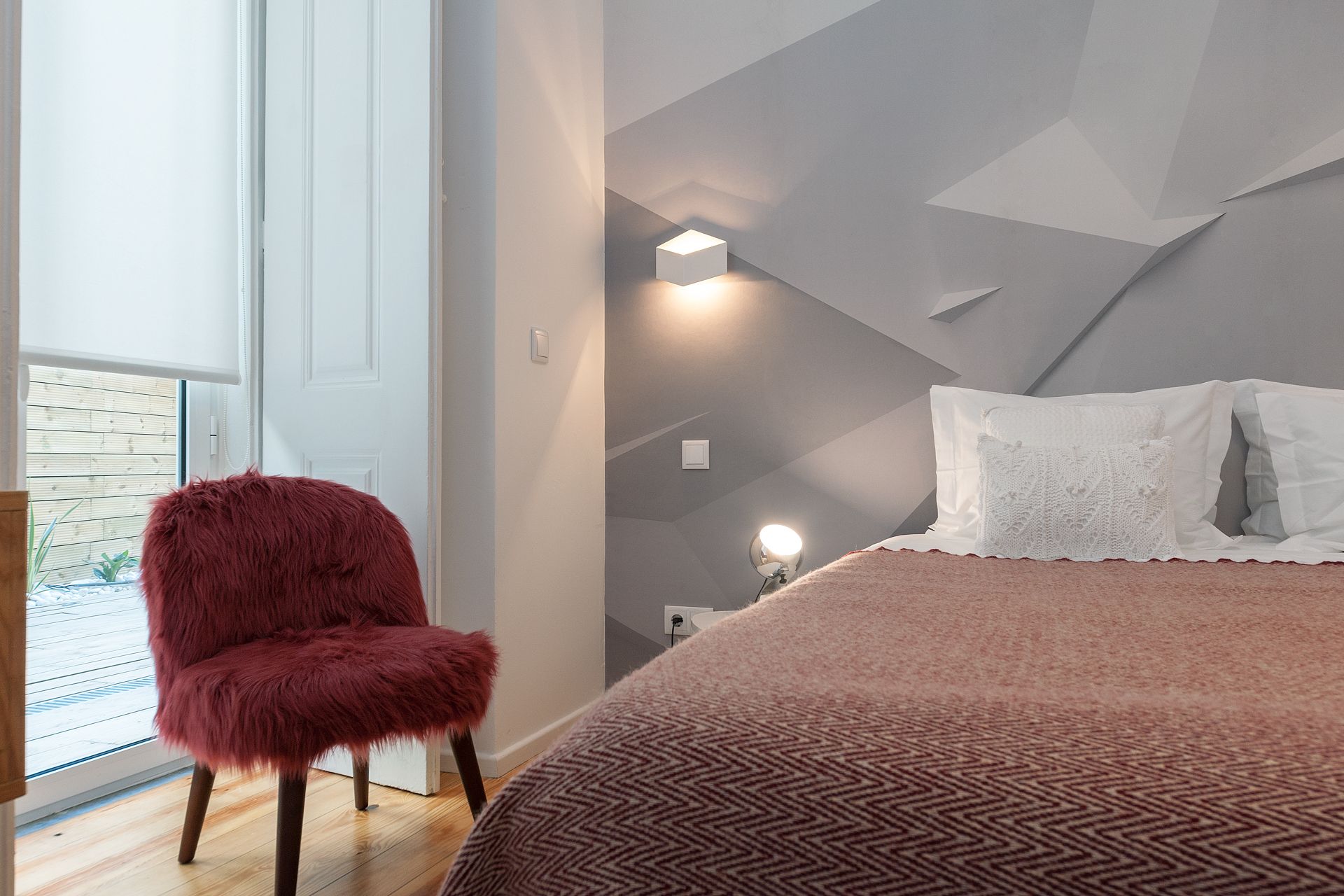 A bedroom with a bed , chair and window. Designed by Cheese & Wine Suites, Lisbon.