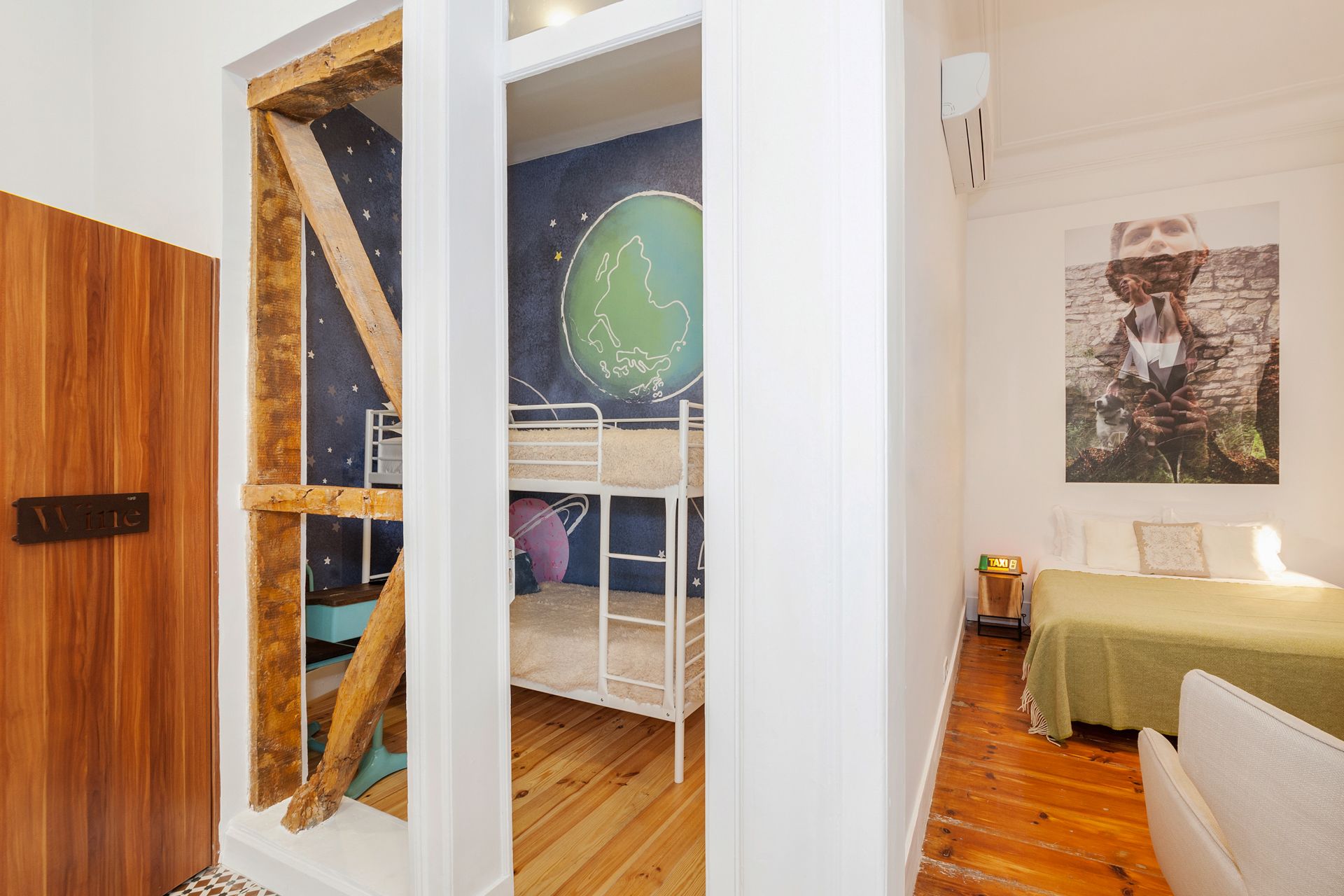 A bedroom with bunk beds and a painting on the wall.