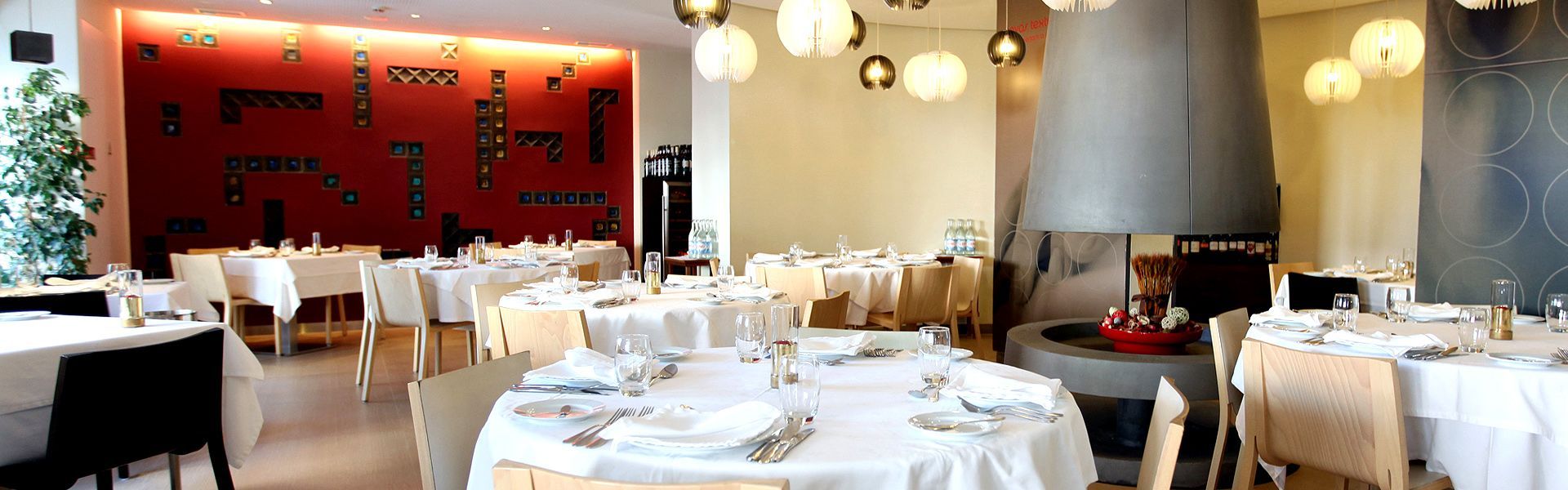 A restaurant filled with tables and chairs and a fireplace