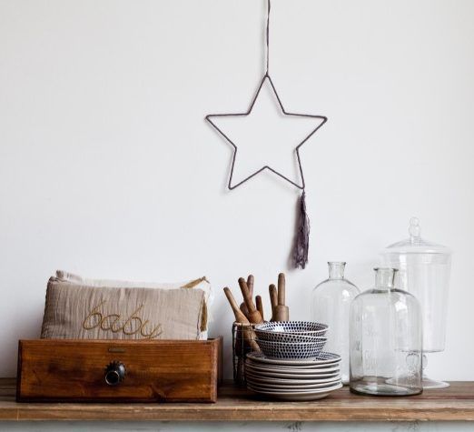 A wooden shelf with a star hanging from the wall. Shopping in Principe Real, Lisbon.