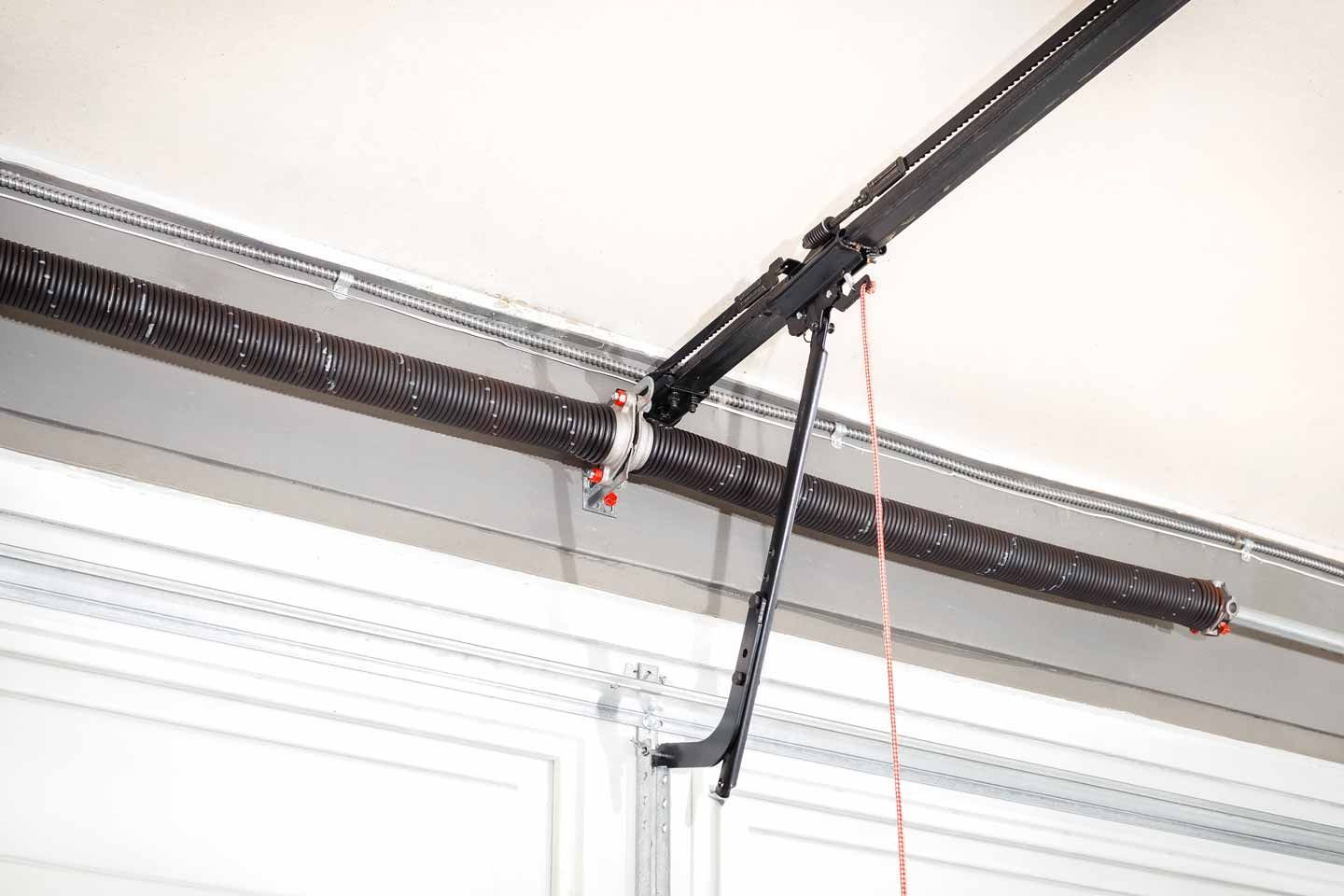 Garage door opener rail and hanging cables near the ceiling