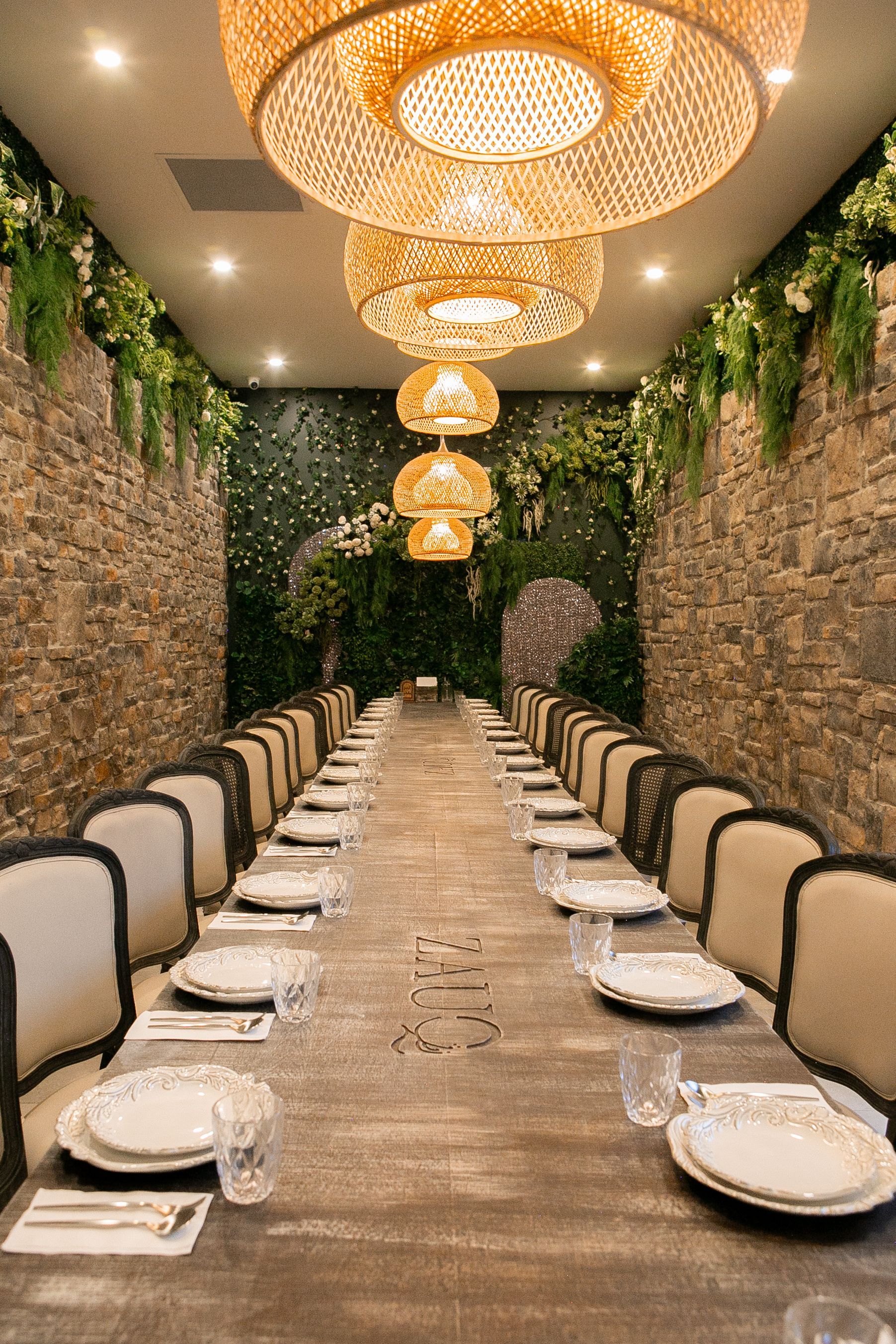 A wooden tray filled with meat , french fries , cabbage and sauce.