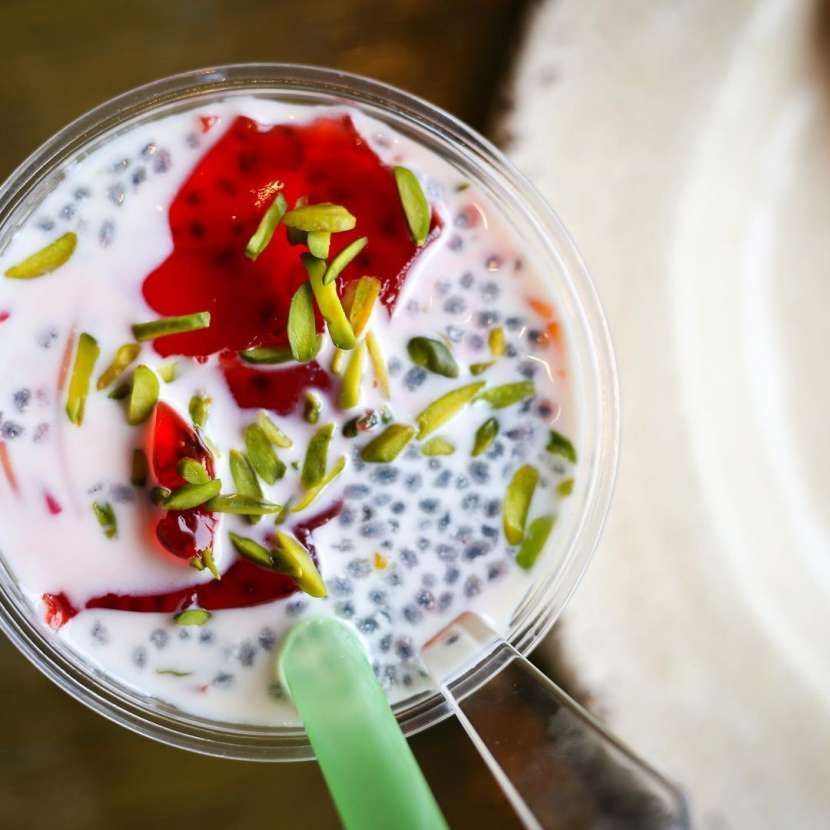 A bowl of food with a green spoon in it