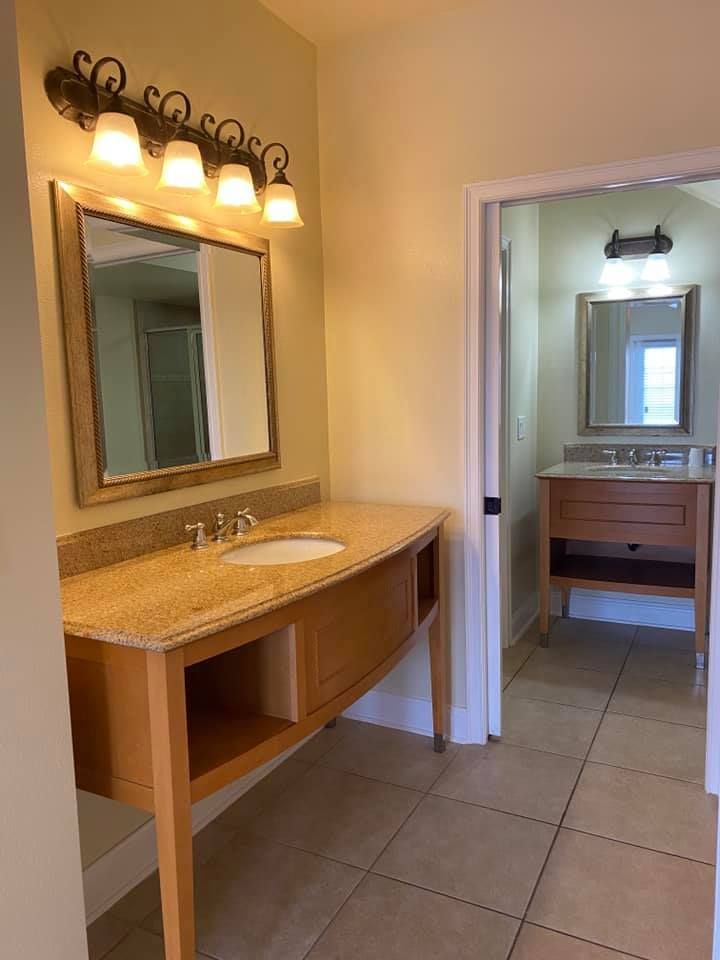 A bathroom with two sinks and a mirror.