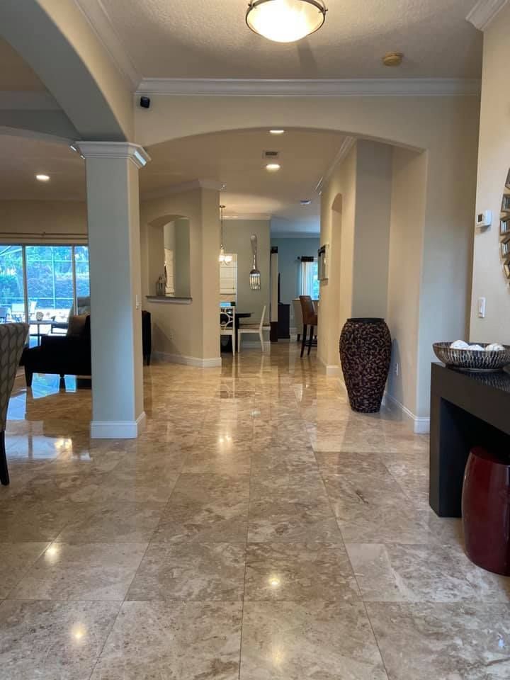 A large hallway in a house with a marble floor.