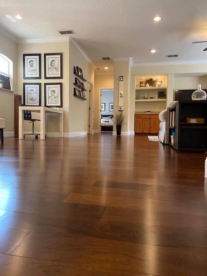 A living room with hardwood floors and a couch.
