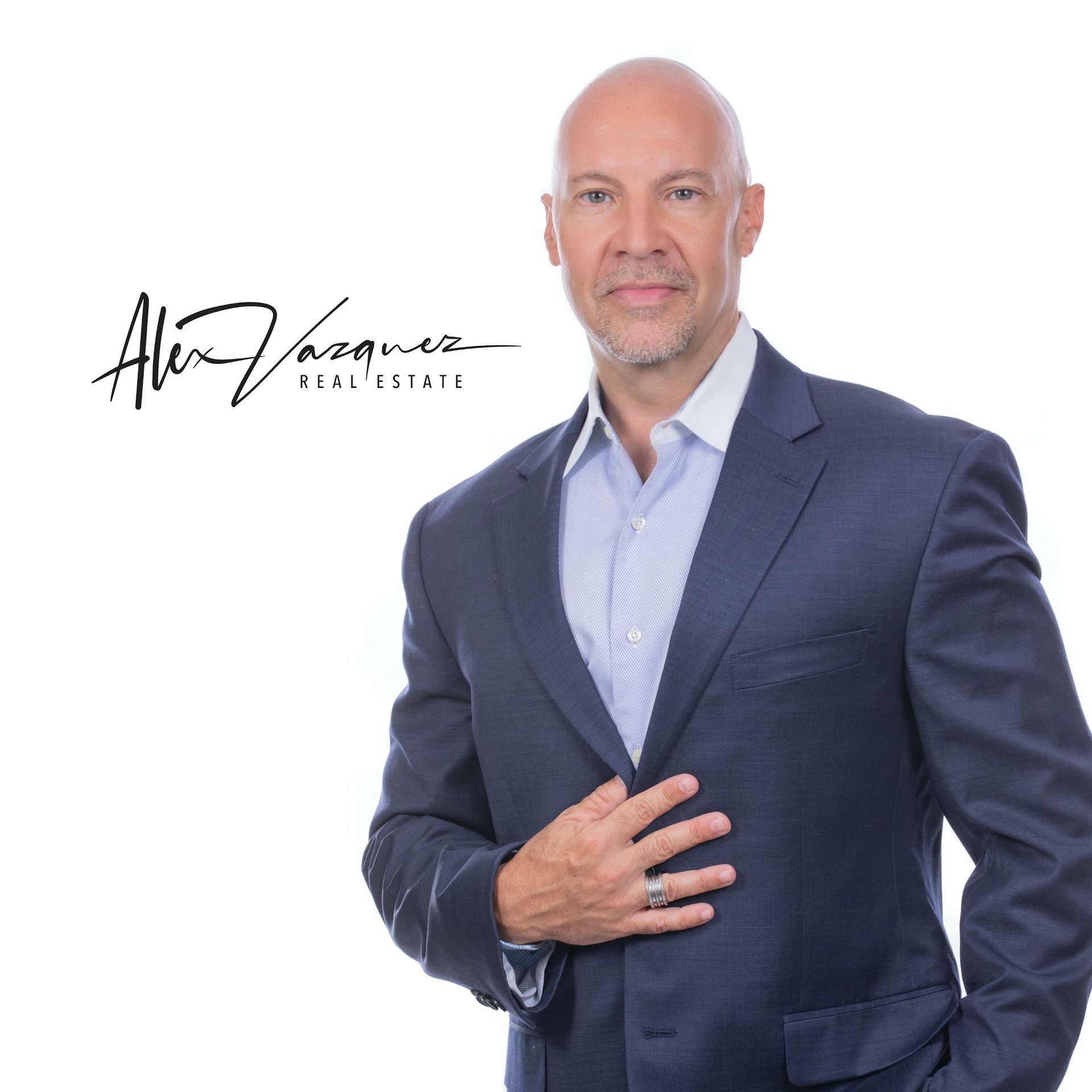 A man in a suit has the name alex vasquez written on his chest