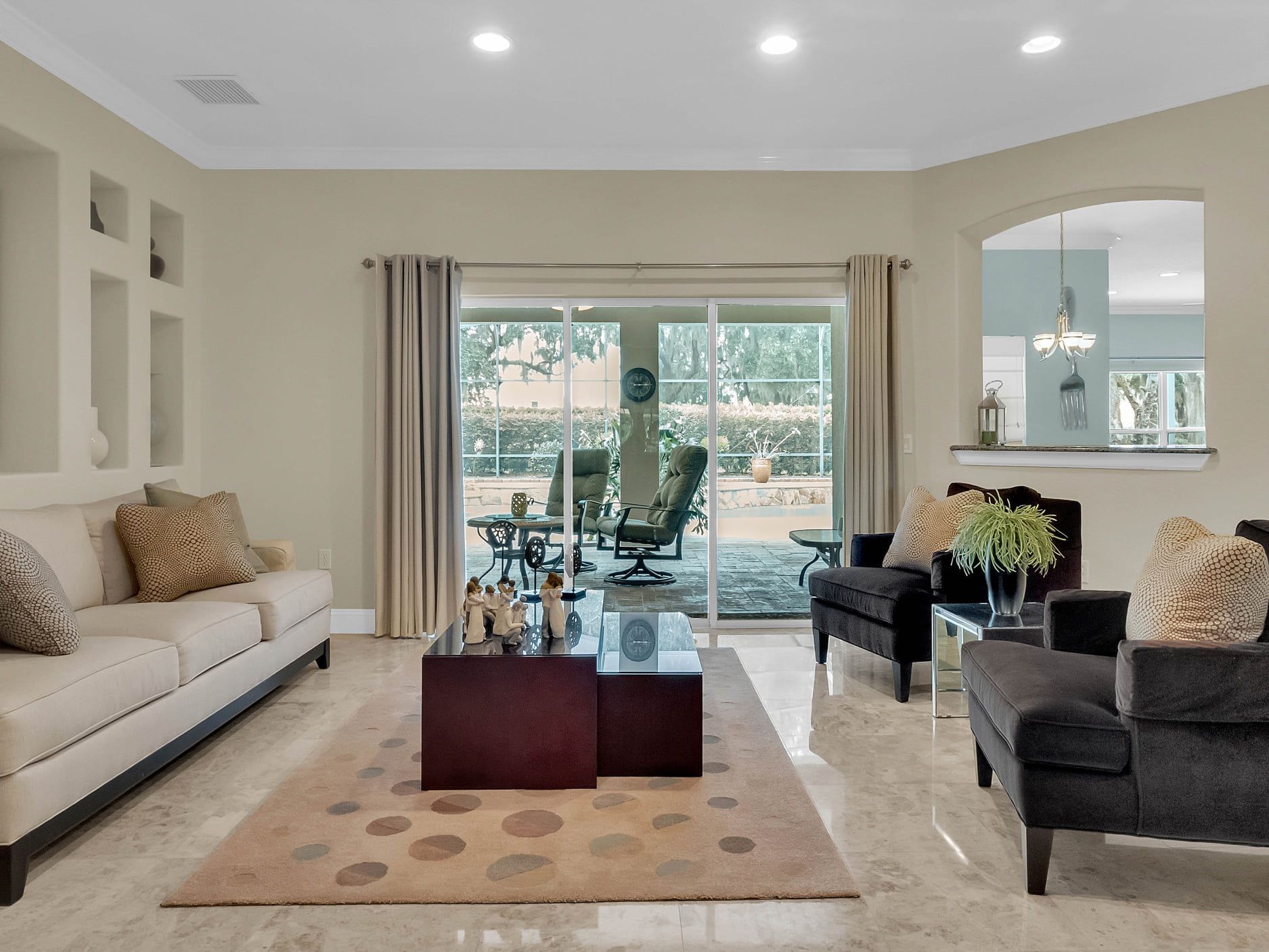 A living room with a couch and chairs and a coffee table