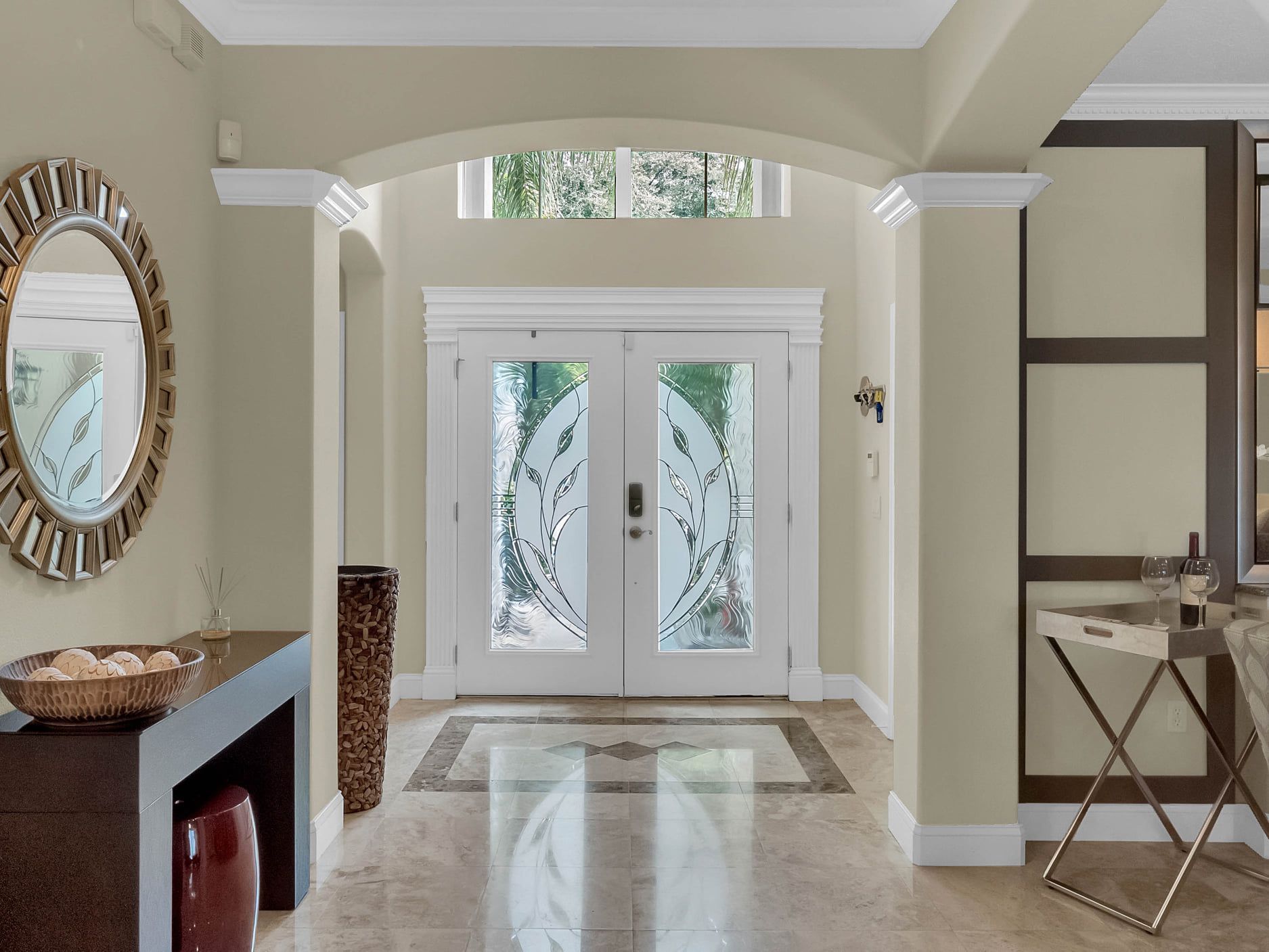 A hallway in a house with a mirror and a table