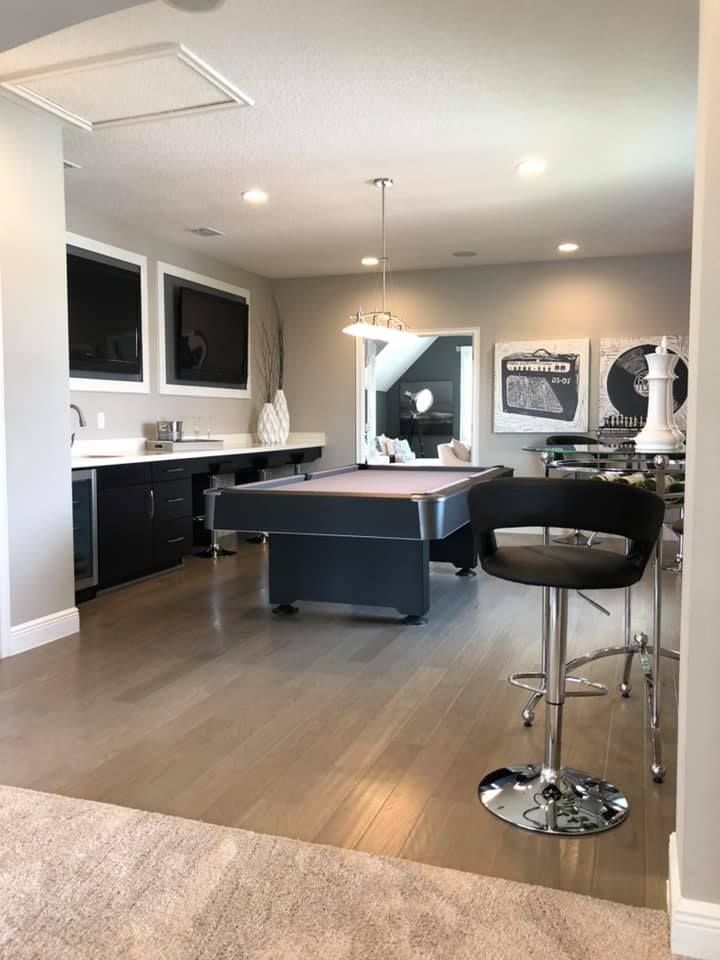 There is a pool table in the middle of the room.