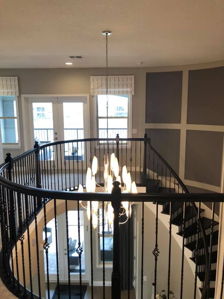 A staircase with a chandelier hanging from the ceiling