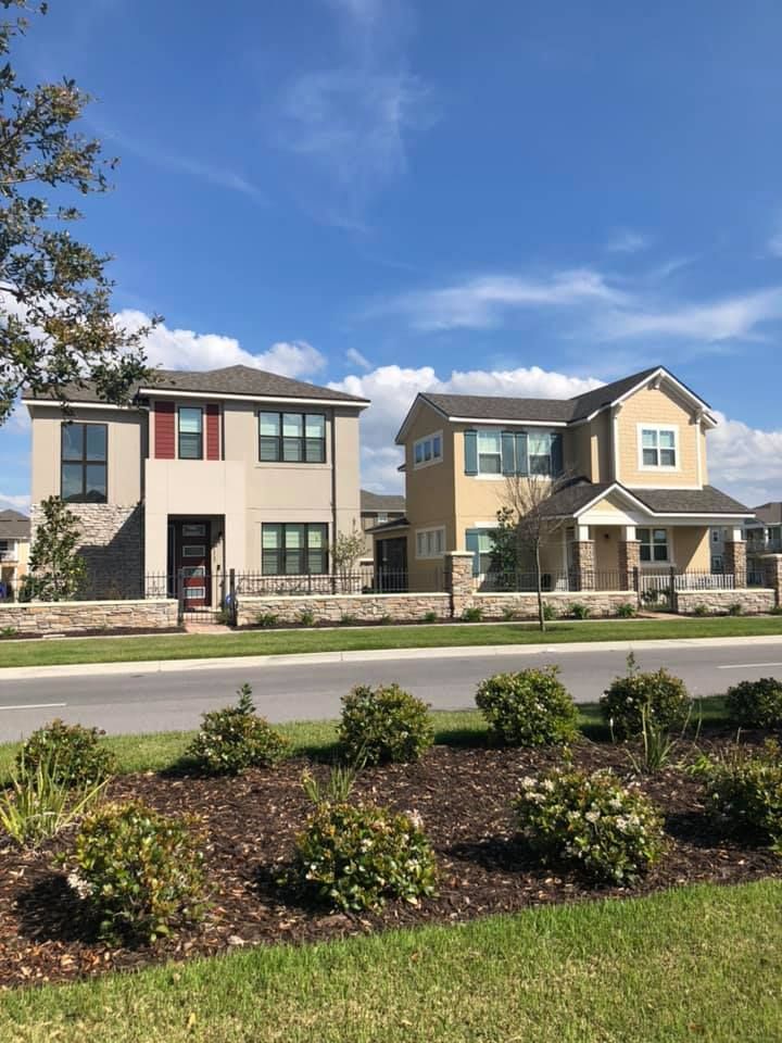 A couple of houses sitting next to each other on the side of a road.