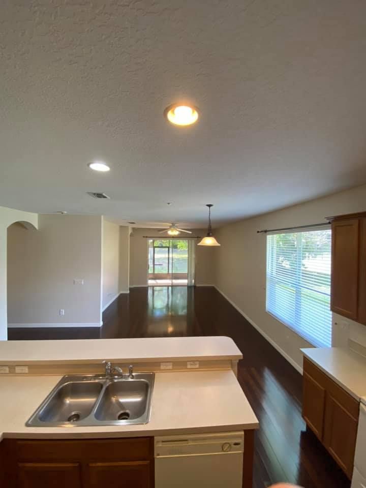 A kitchen with a sink and a dishwasher in a house.