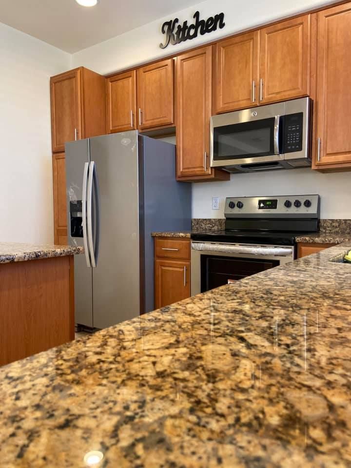 A kitchen with stainless steel appliances and granite counter tops