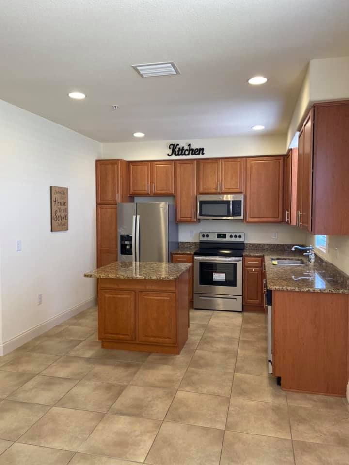 A kitchen with stainless steel appliances and wooden cabinets