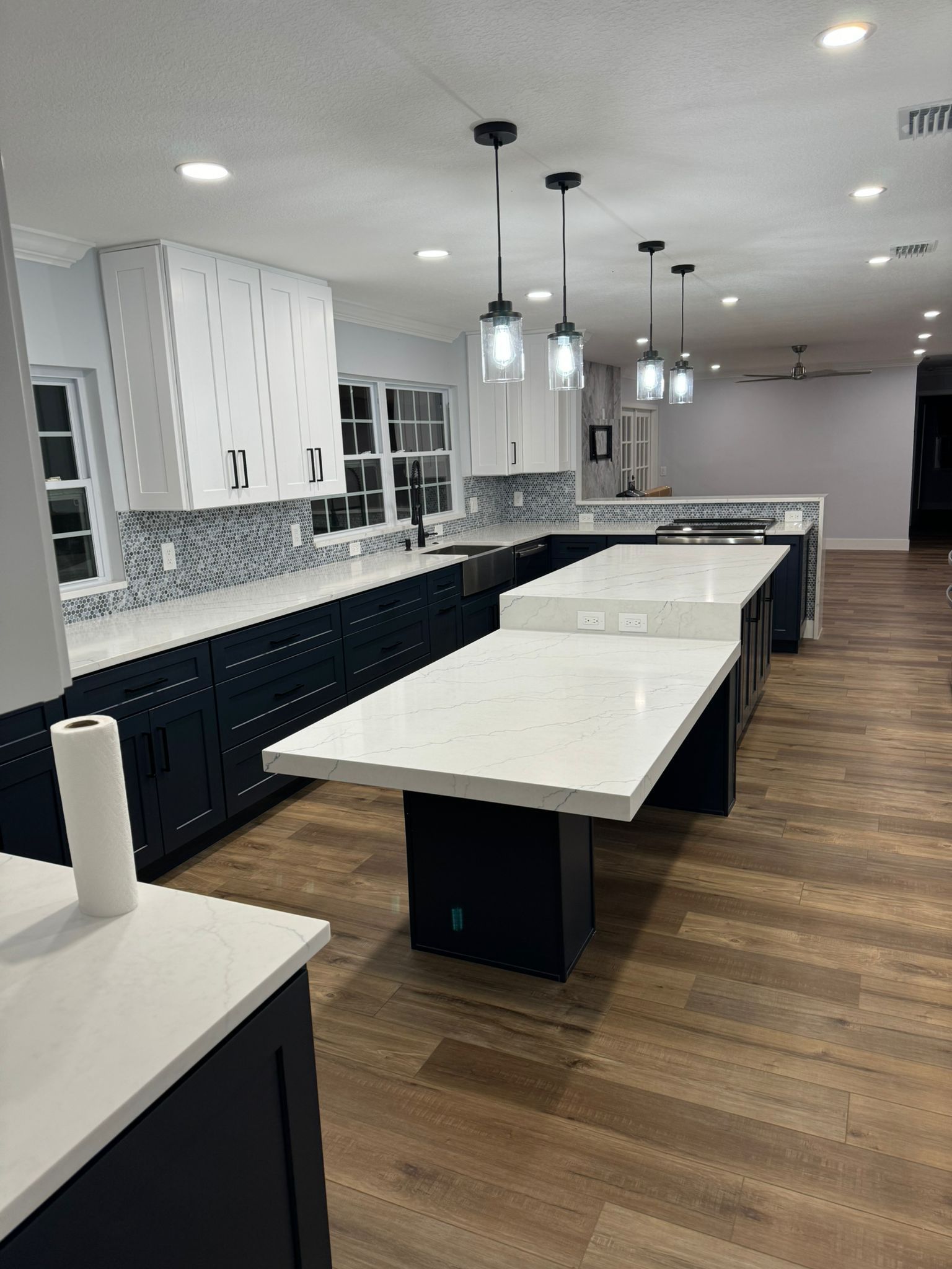 A large kitchen with a lot of counter tops and cabinets.