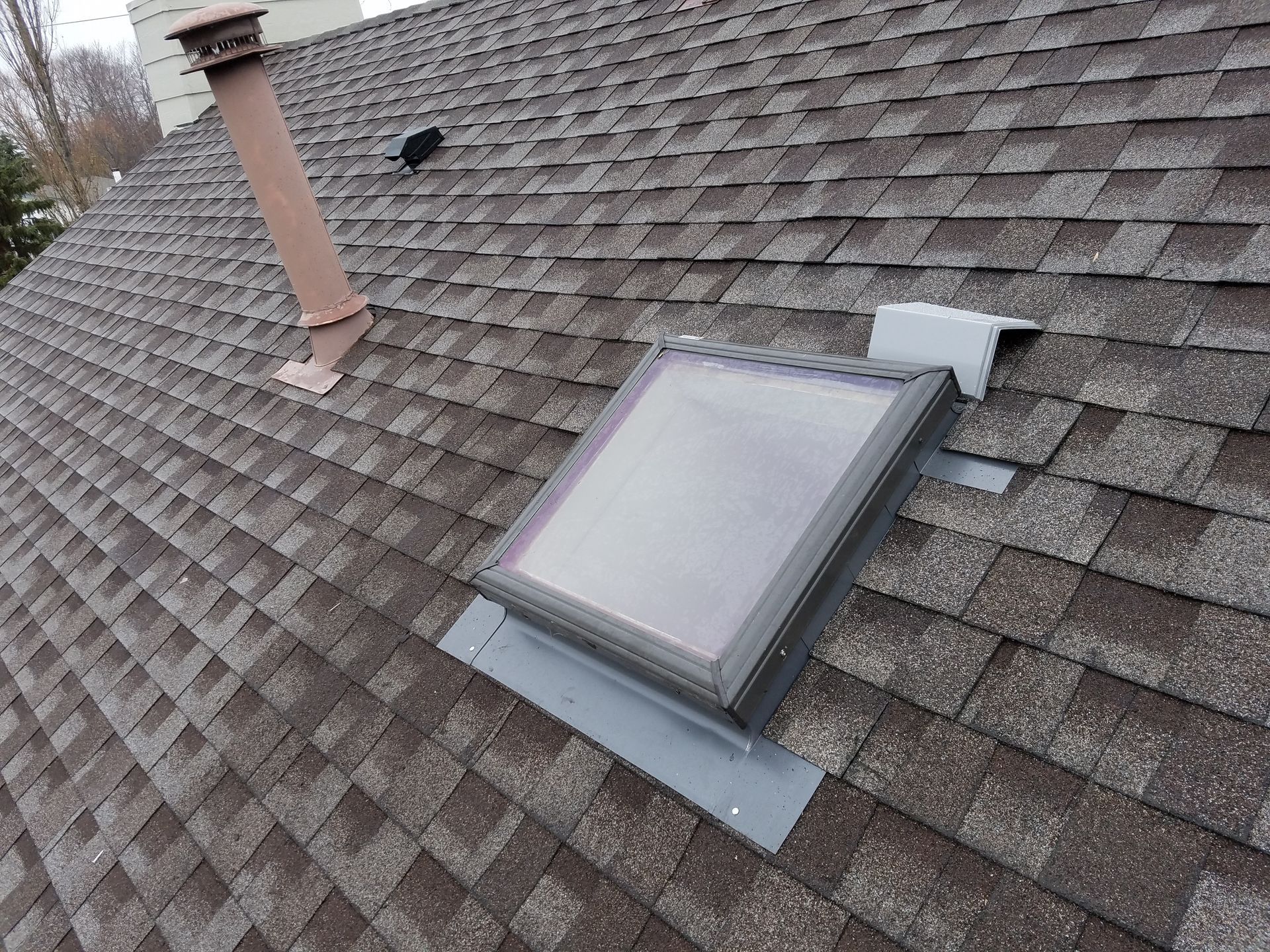 There is a skylight on the roof of a house.
