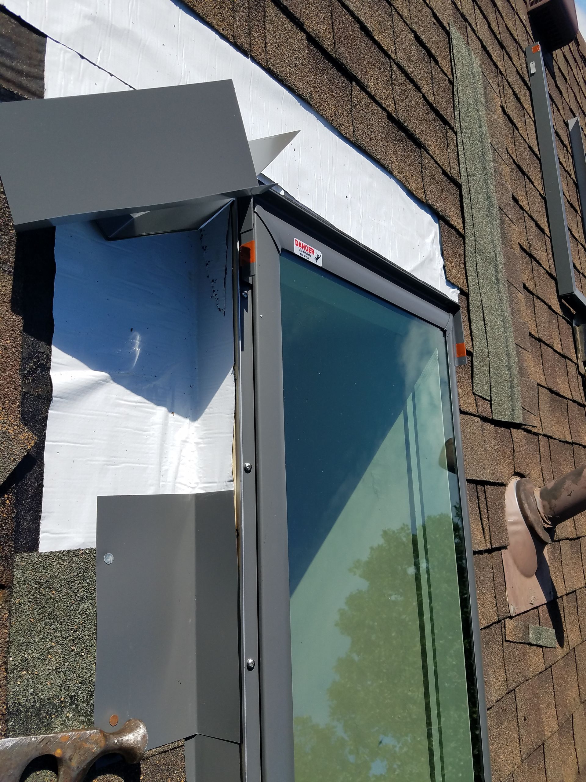 A window is being installed on a brick building