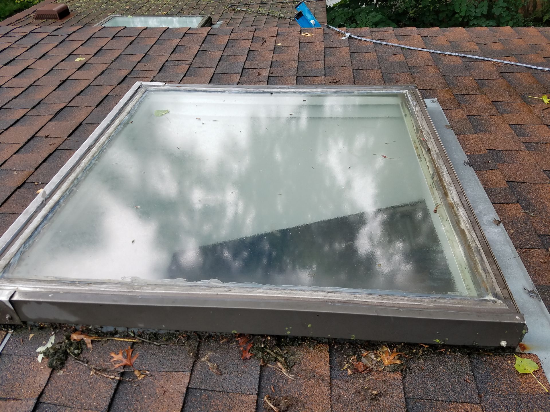 A skylight is sitting on top of a roof.