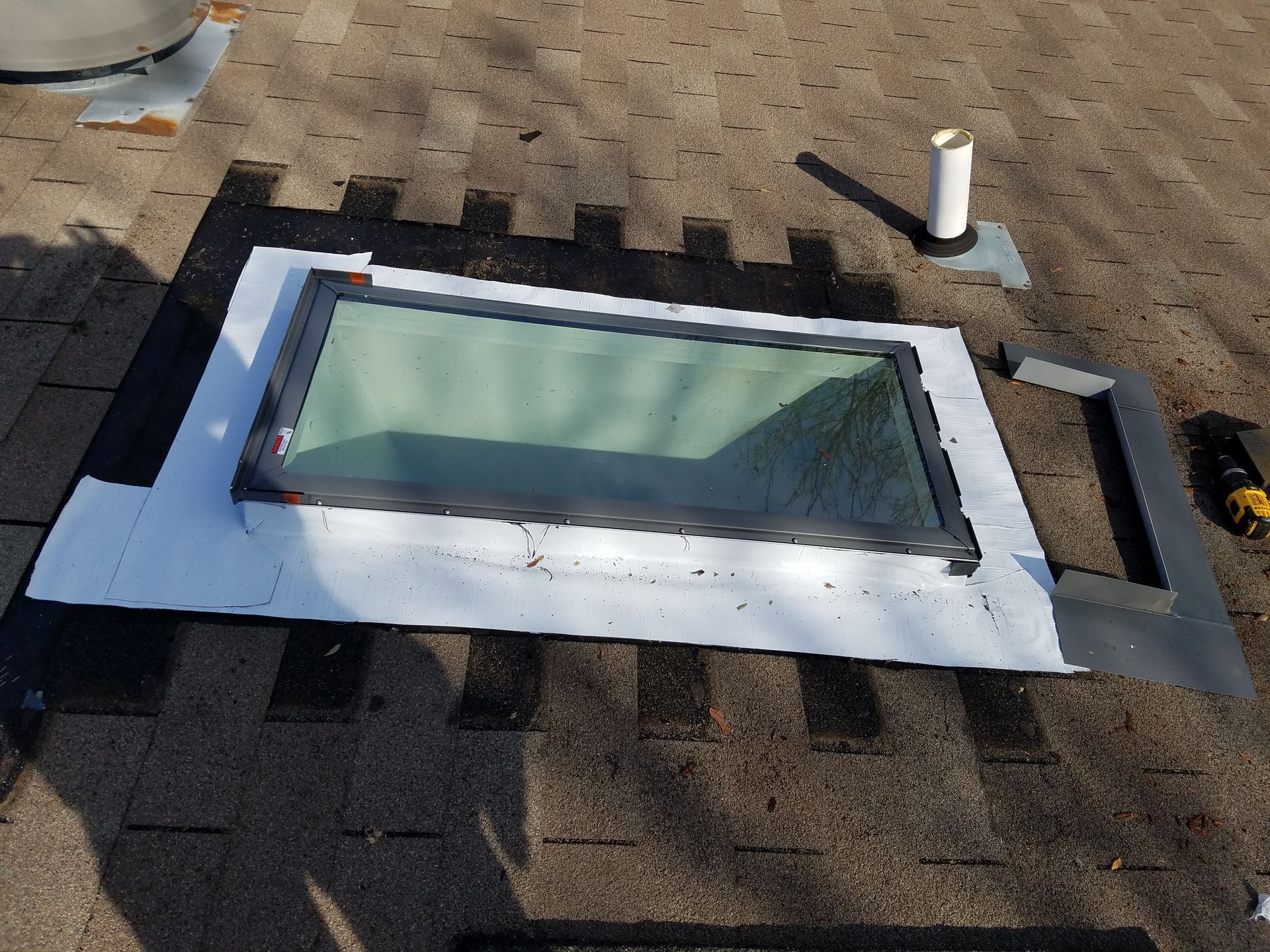 A skylight is sitting on top of a roof.