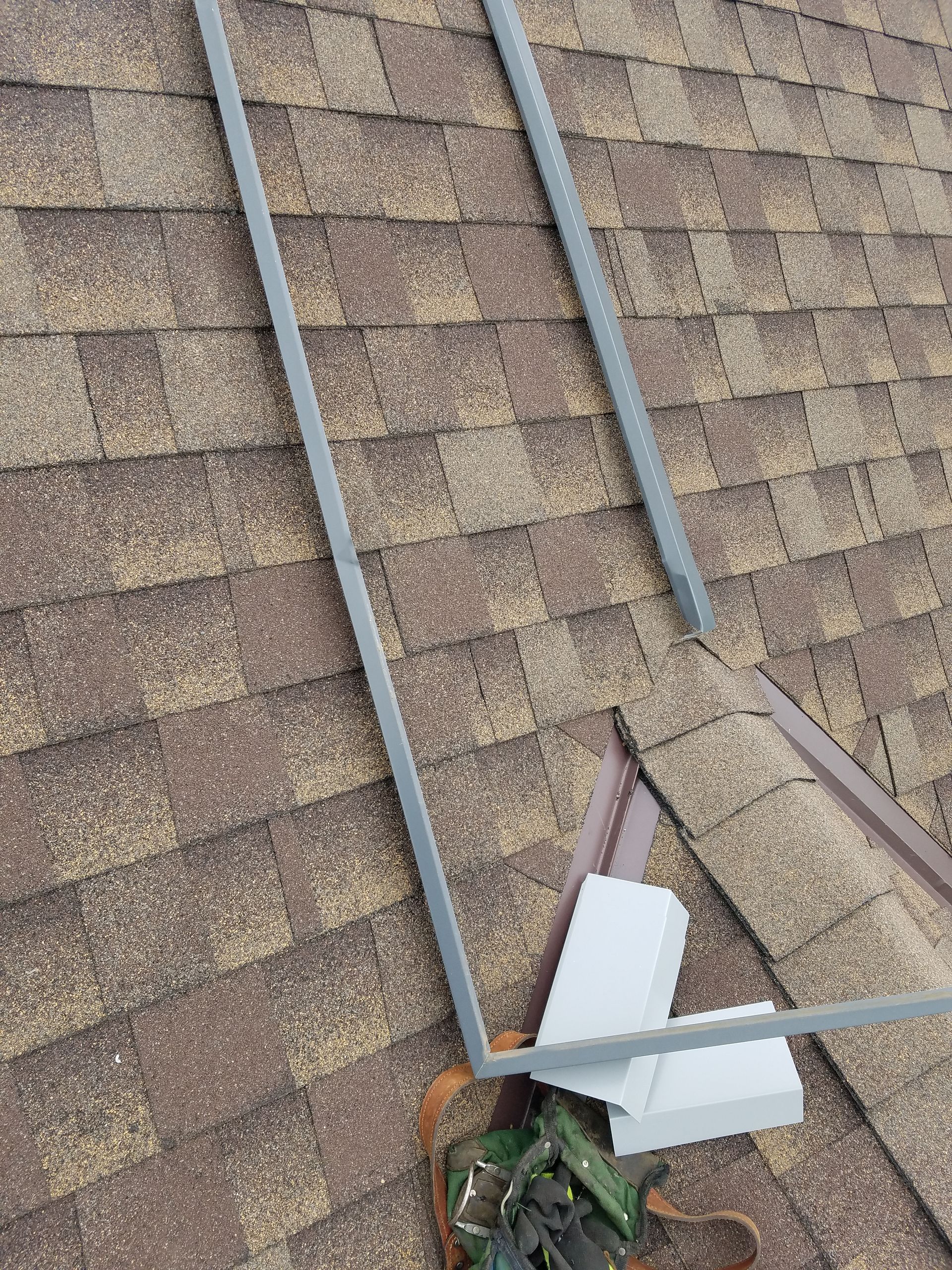 A close up of a roof with a ladder on it.
