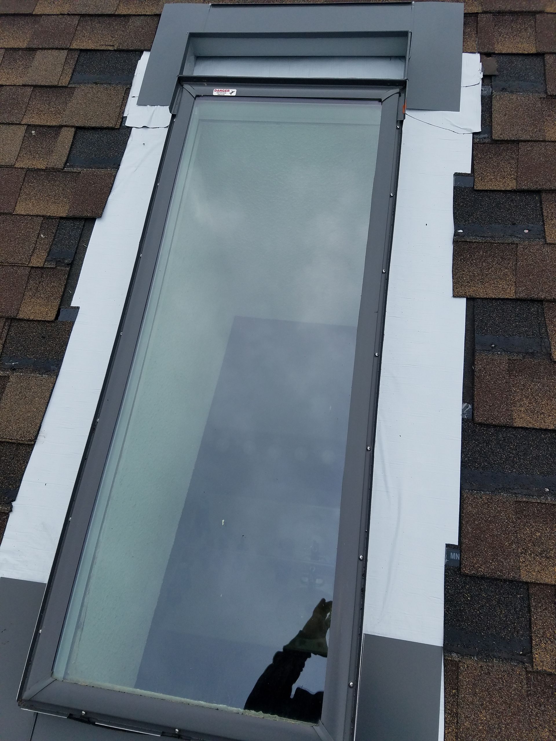 A skylight is sitting on top of a roof