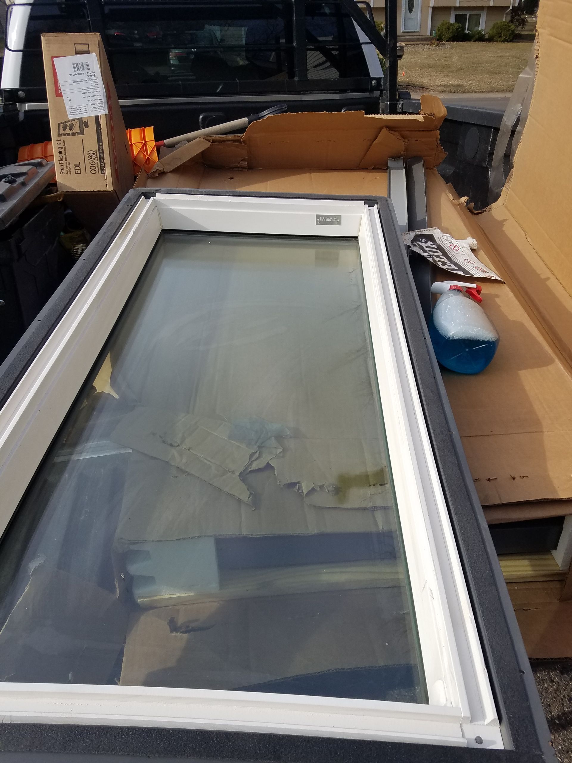 A large window is sitting on top of a wooden table.