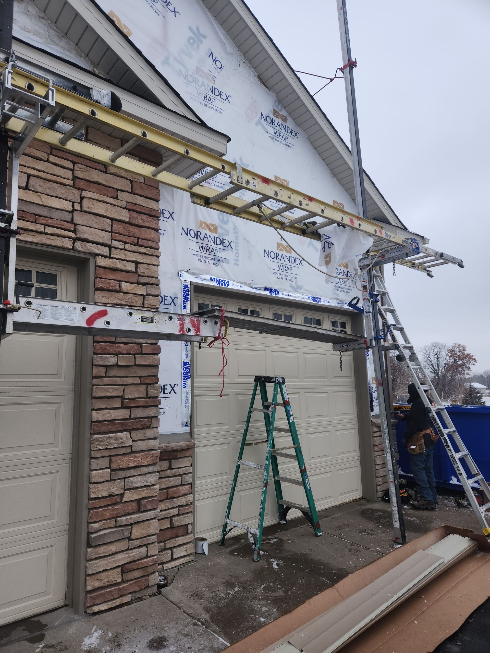 A ladder is attached to the side of a garage door.