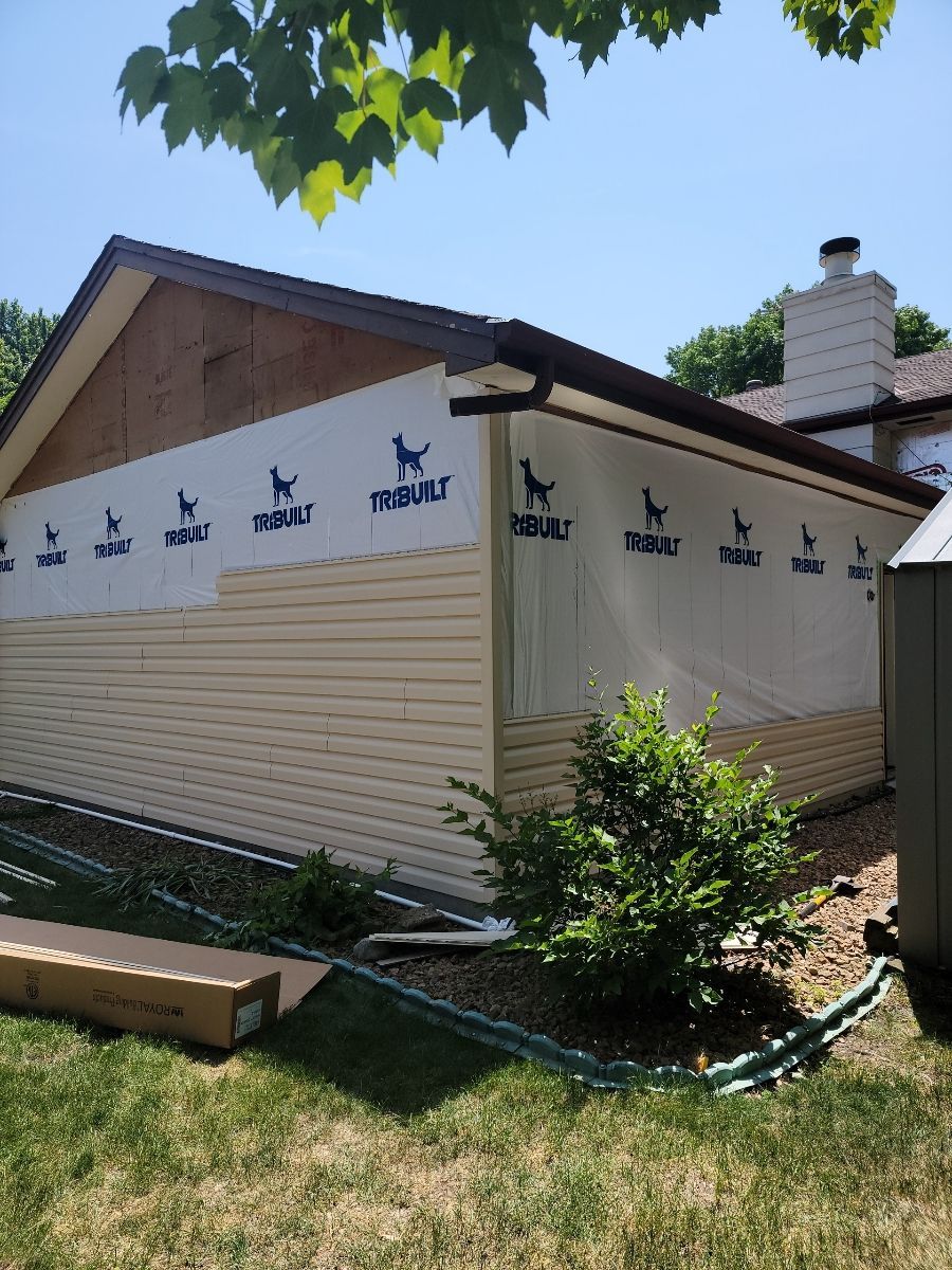 A house that is being remodeled with a lot of siding on it