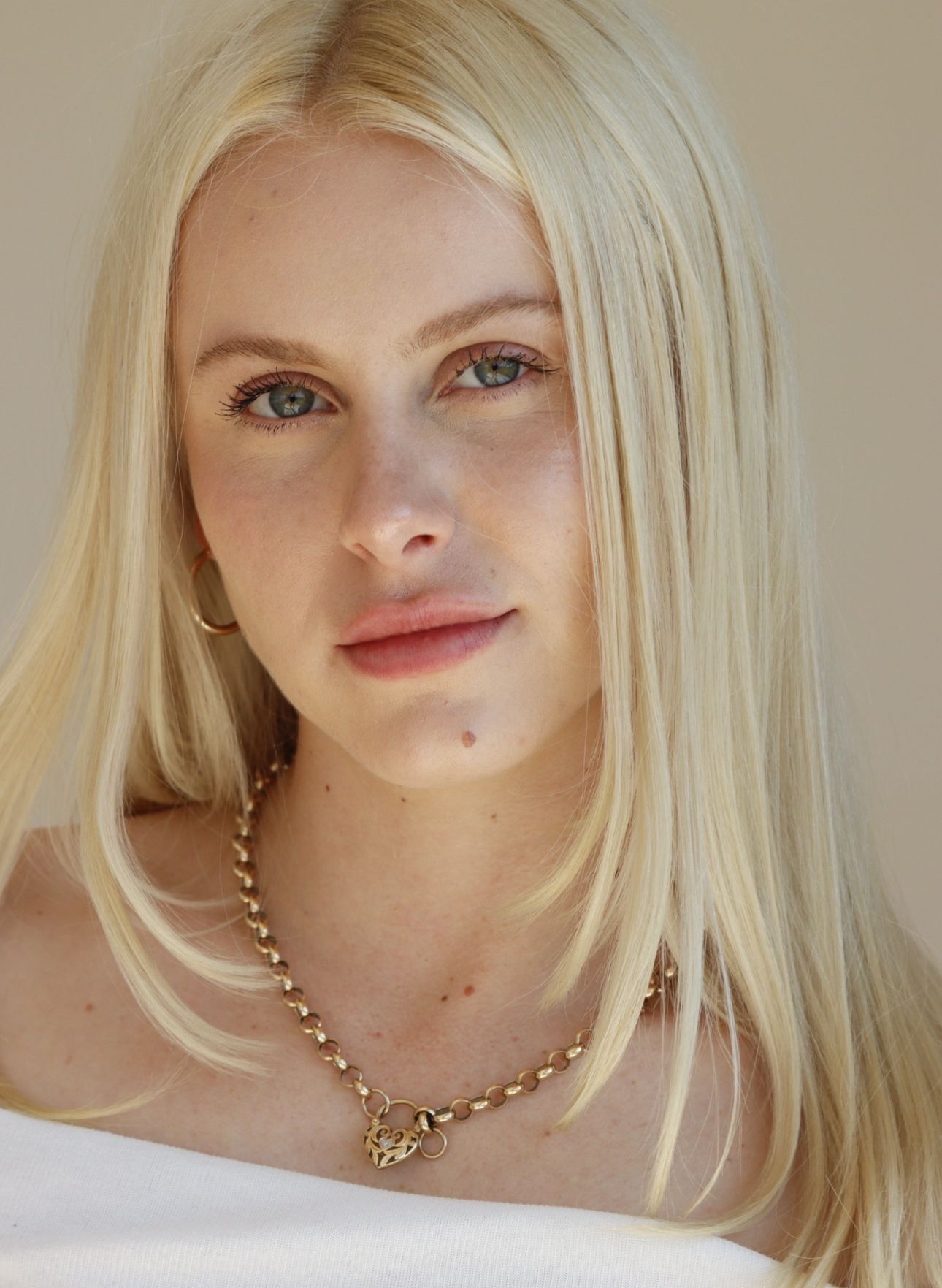 A Woman is Getting Her Hair Blow Dried by a Hairdresser in a Salon — Dudes n Dolls Hair Lounge In Warners Bay, NSW