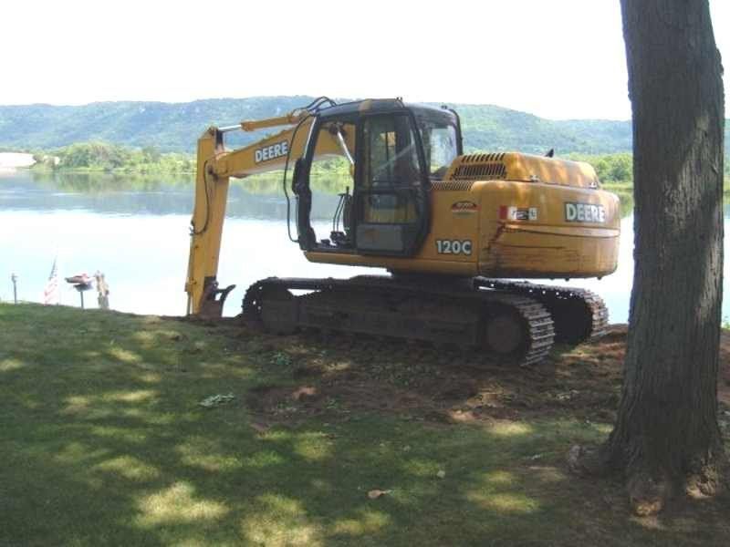 Excavator Near the Tree — Kellogg, MN — Danckwart Landscaping LLC