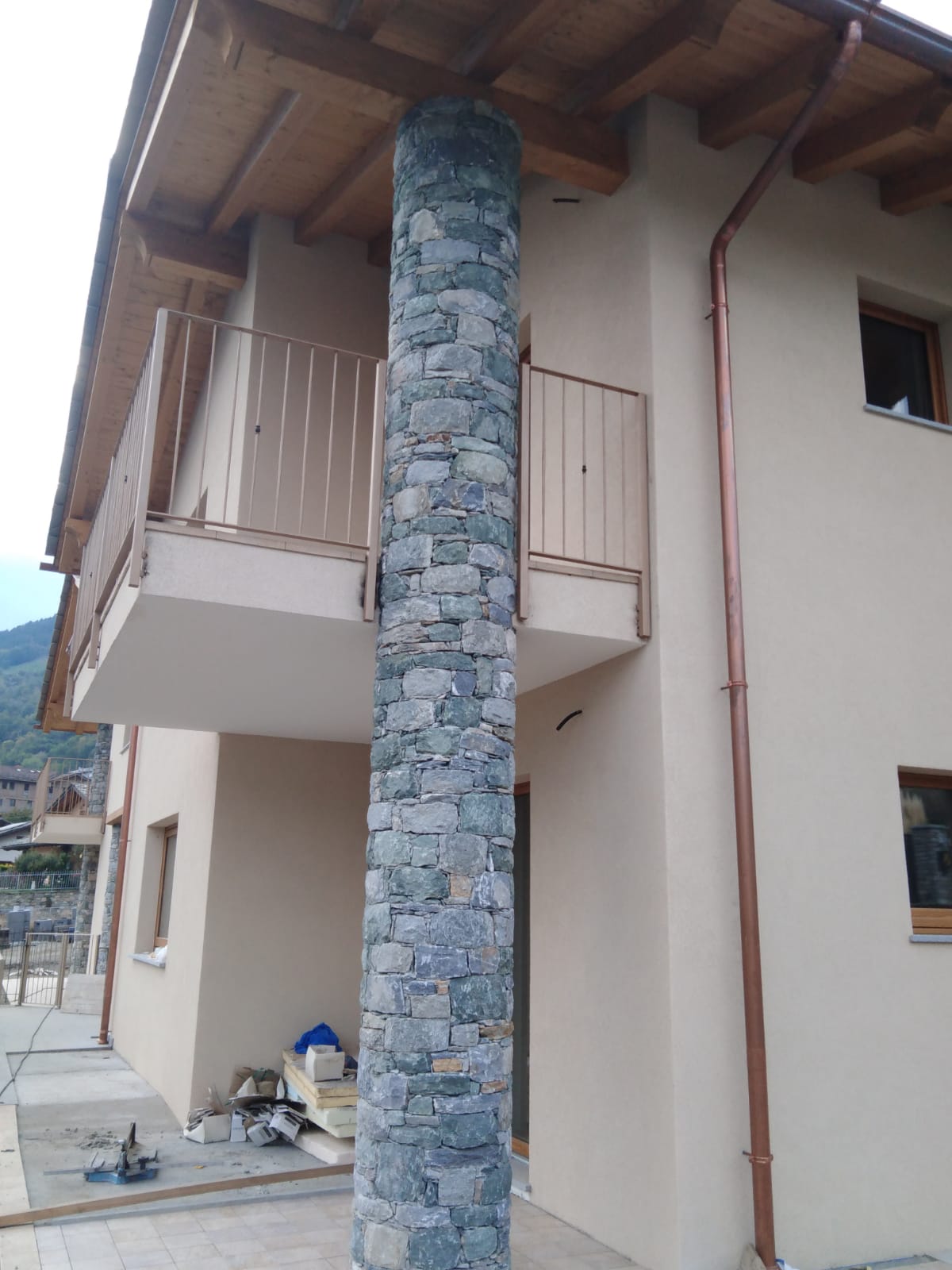 vue extérieure de la maison avec colonne de pierre grise