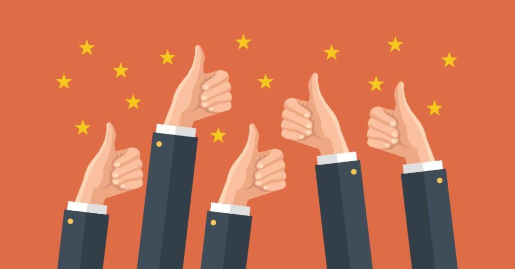 A group of people are giving a thumbs up sign.
