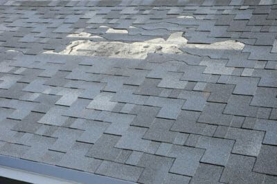 Roof with Missing Shingles Due to Wind Damage