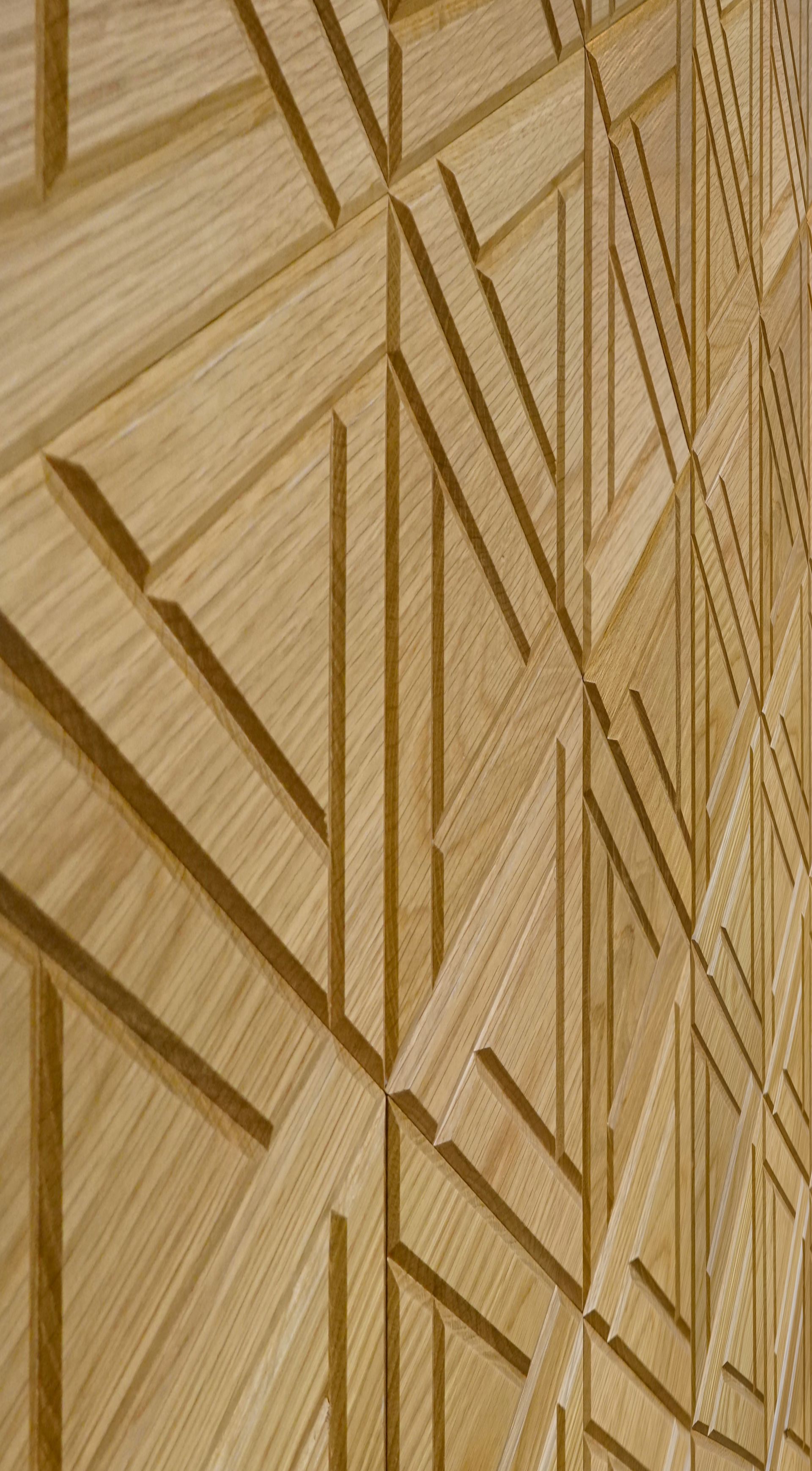 A close up of a wooden wall with a geometric pattern on it.