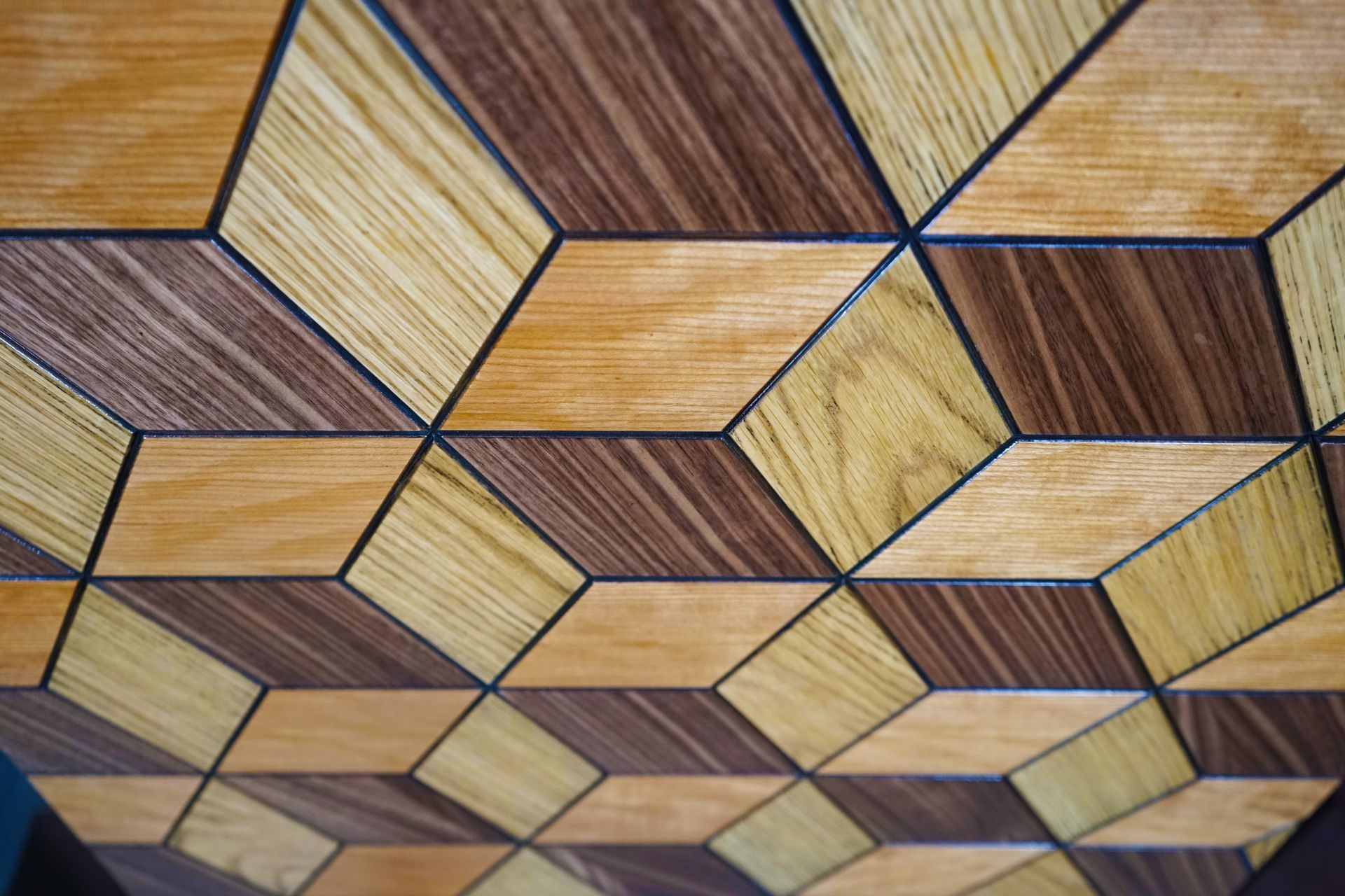 A close up of a wooden table with a geometric pattern on it.