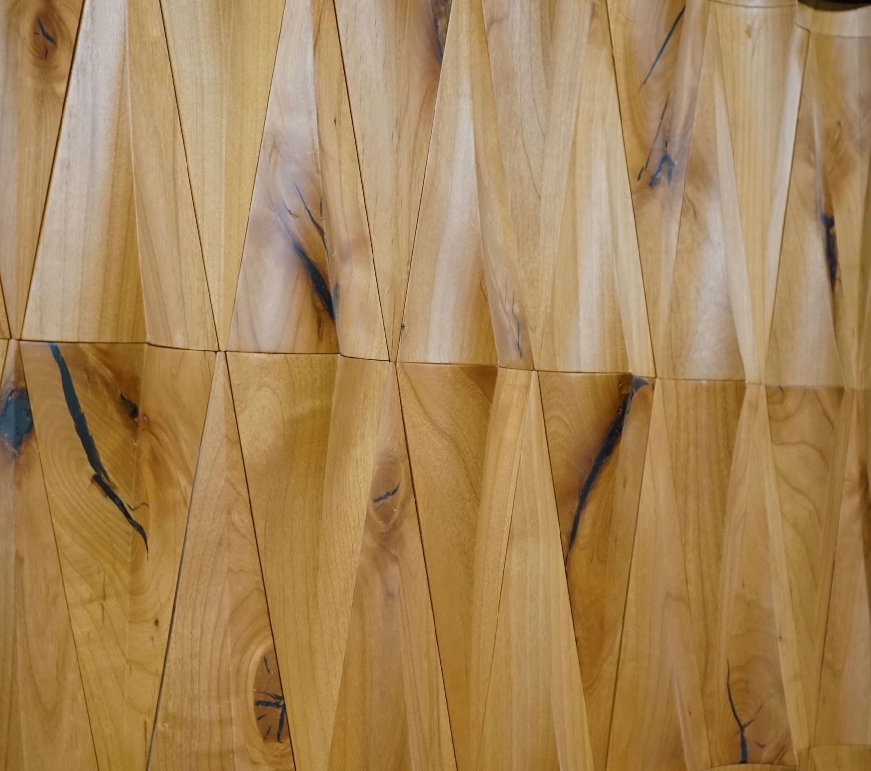 A close up of a wooden wall with a geometric pattern