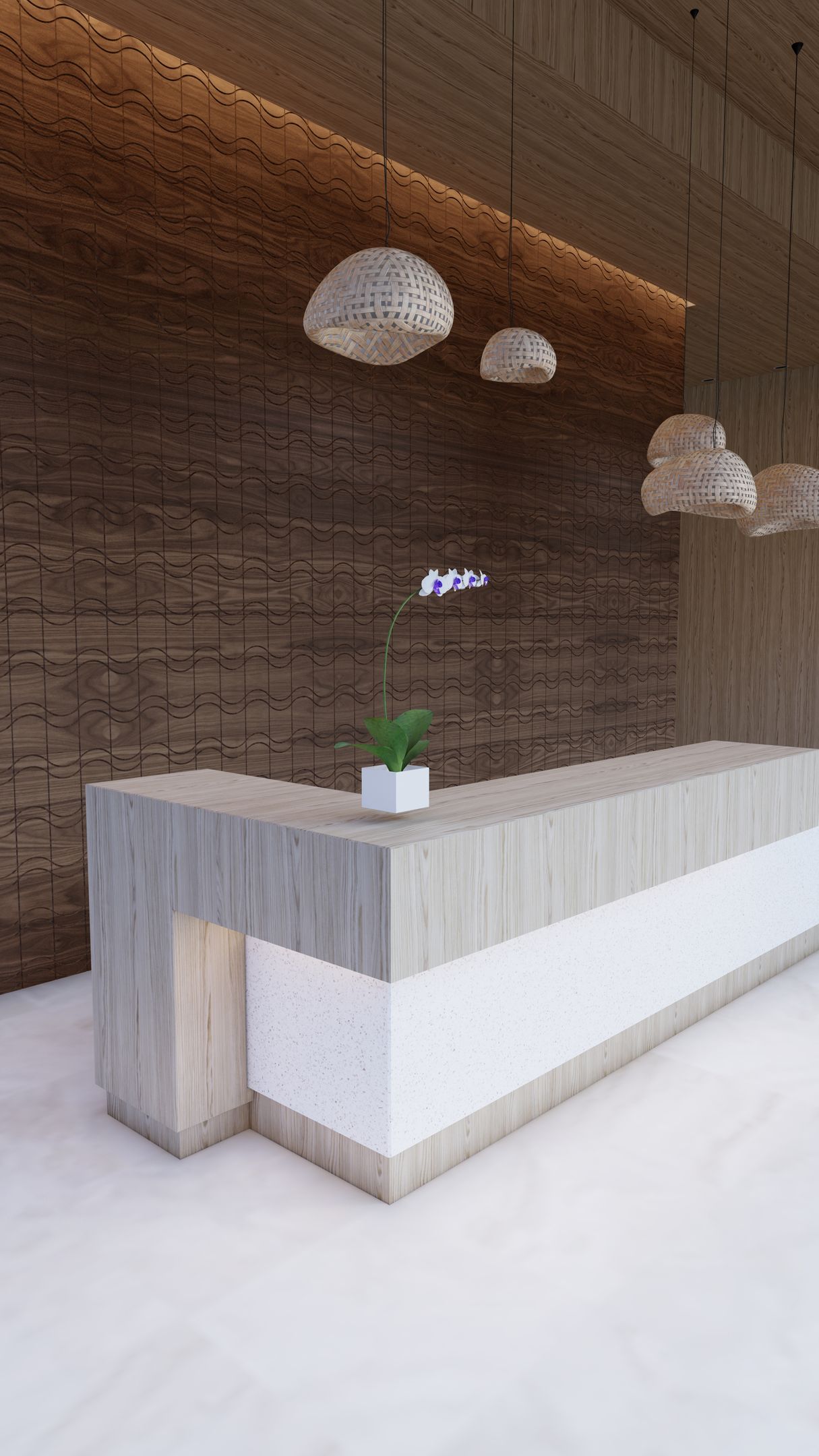 A reception desk with a plant on it in a room with a brick wall.