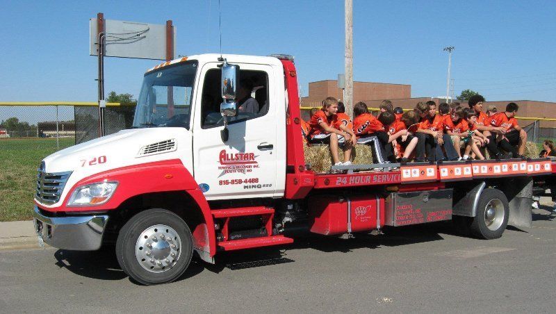 Allstar towing hauling kids on the flatbed