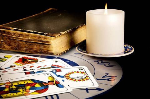tarot cards with old book and burning candle; Shutterstock ID 22524301; PO: N/A; Job: BULK; Client: N/A; Other: BULK