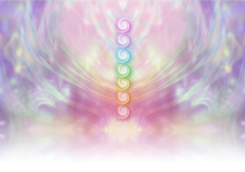 Symmetrical pastel colored wispy misty background with vertical row of seven chakras place in centre