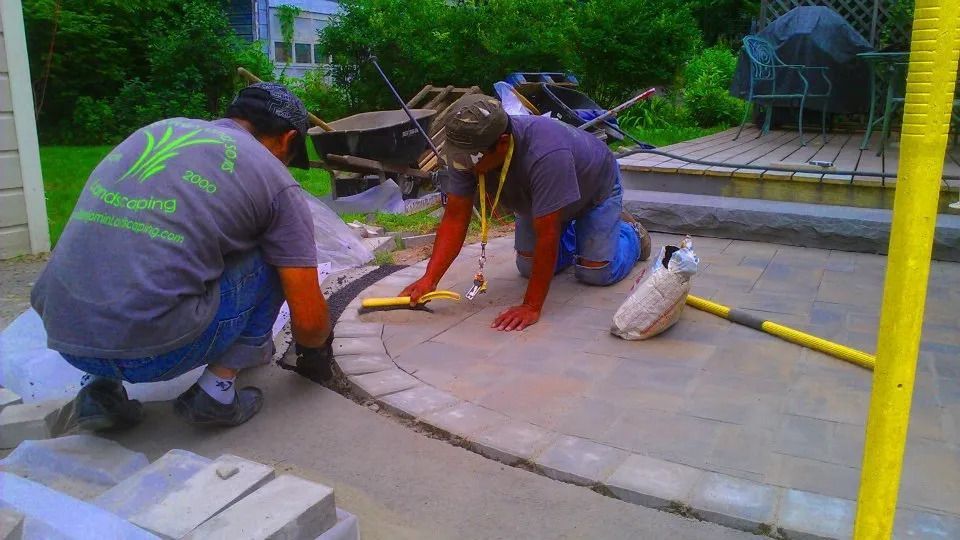 Men working on a patio — Newburgh, NY — Benjamin & Sons Landscaping