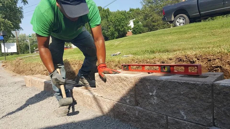 A person with a hammer — Newburgh, NY — Benjamin & Sons Landscaping