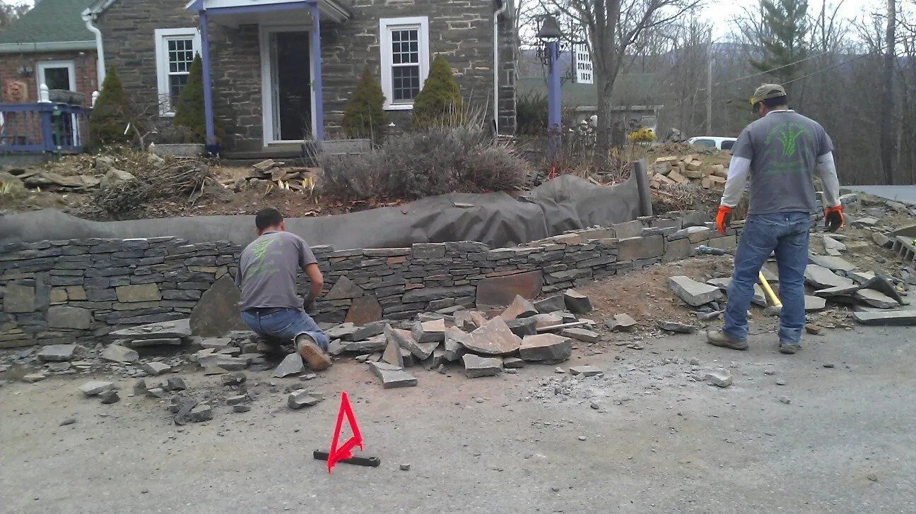 Men building a stone wall — Newburgh, NY — Benjamin & Sons Landscaping